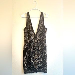 Beautiful heavy Bebe black dress with code sequence size large.